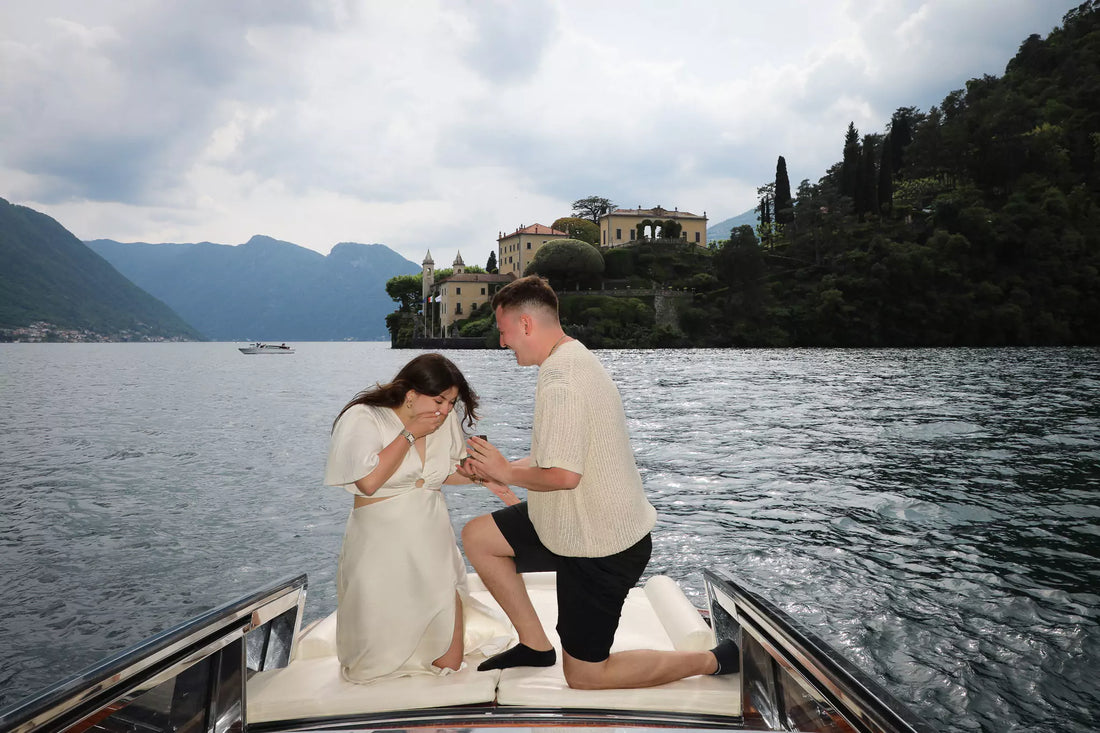 Romantic surprise proposal on a private boat in Lake Como at sunset with a couple celebrating on the water.