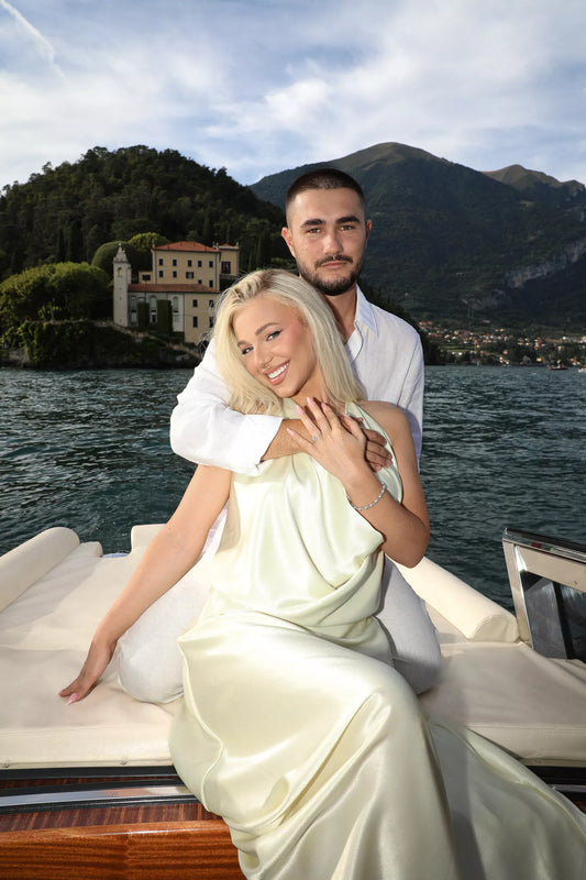 Smiling bride-to-be showing her engagement ring during a Lake Como boat photo session