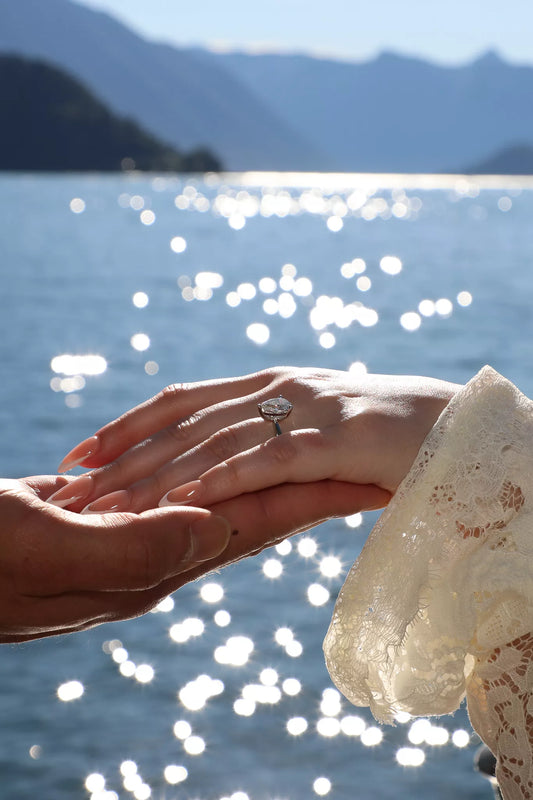 Cinematic close-up of an engagement ring and intertwined hands during a Lake Como proposal video moment