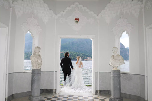 Bride and groom walking in Villa Melzi Gardens during a Lake Como wedding in spring, showing the best time to get married in Italy’s most romantic destination.