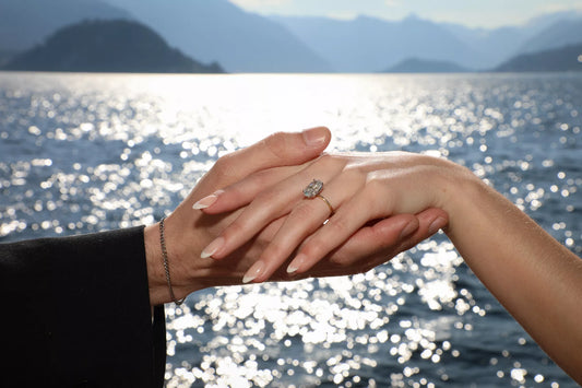 Romantic destination proposal in Lake Como with couple by the lake, historic villas, mountains, and soft golden light
