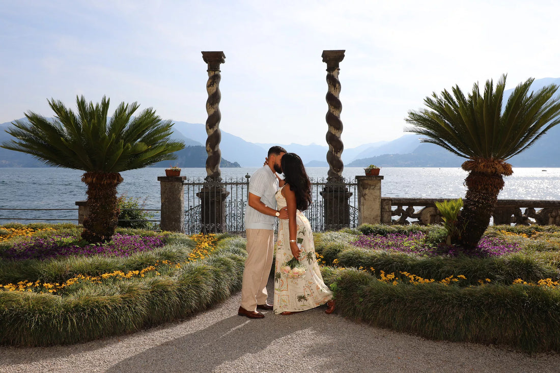 Elegant couple enjoying a romantic Lake Como photoshoot on a private boat near Bellagio with mountain and villa views.