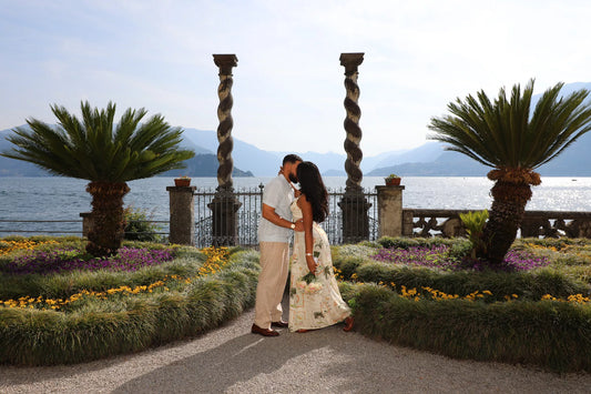 Elegant couple enjoying a romantic Lake Como photoshoot on a private boat near Bellagio with mountain and villa views.