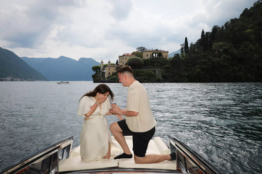 Romantic surprise proposal on a private boat in Lake Como at sunset with a couple celebrating on the water.