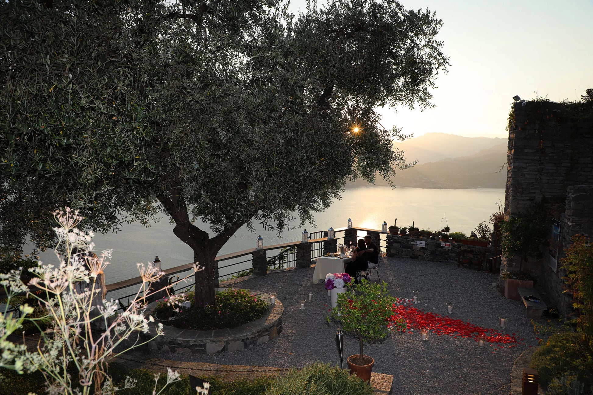 Flower proposal setup at Castello di Vezio during golden hour above Varenna Lake Como
