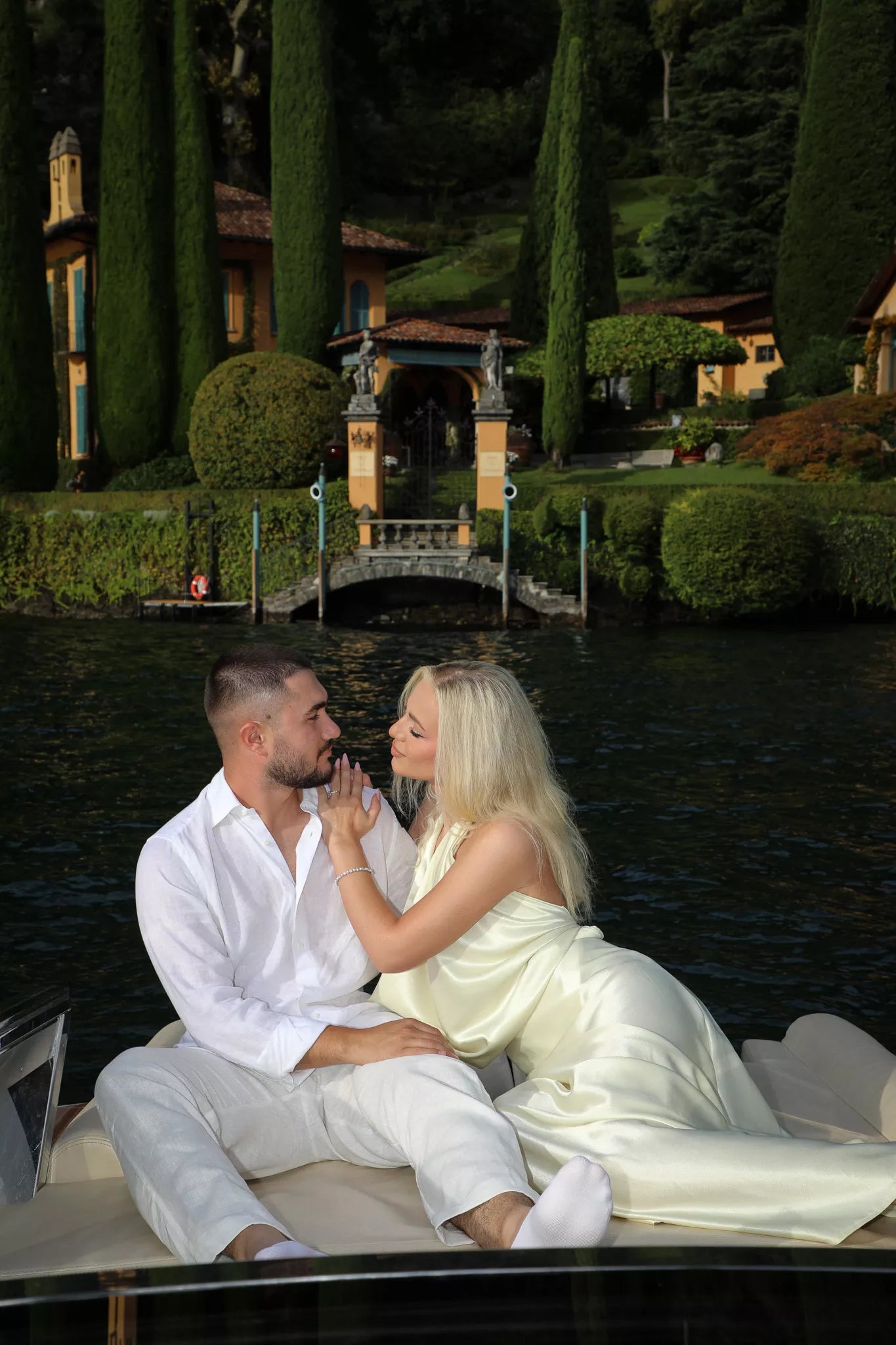 Elegant Lake Como engagement photo shoot with a couple posing by the water