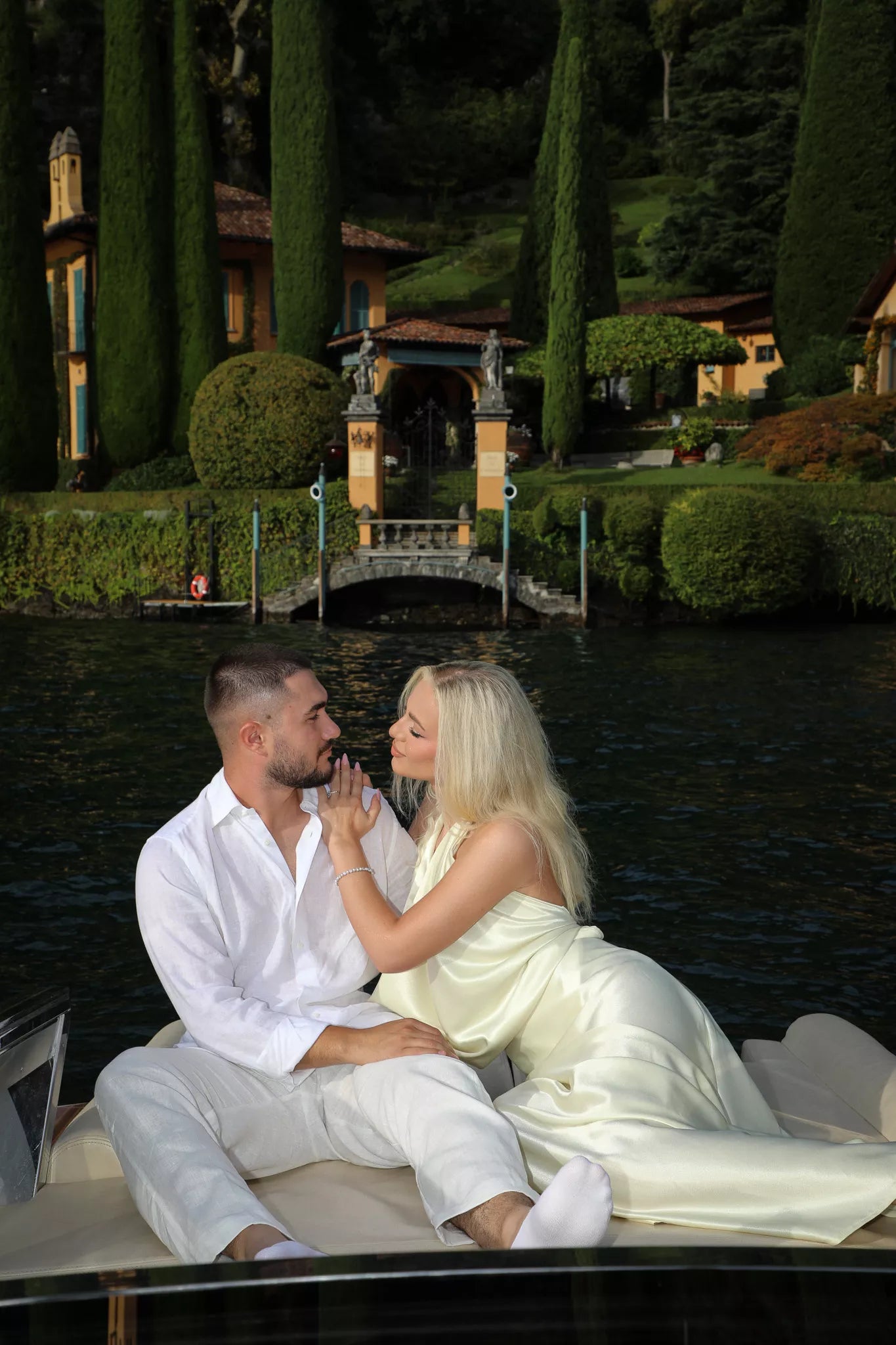 Romantic moment on a private boat passing an ornate villa entrance on Lake Como