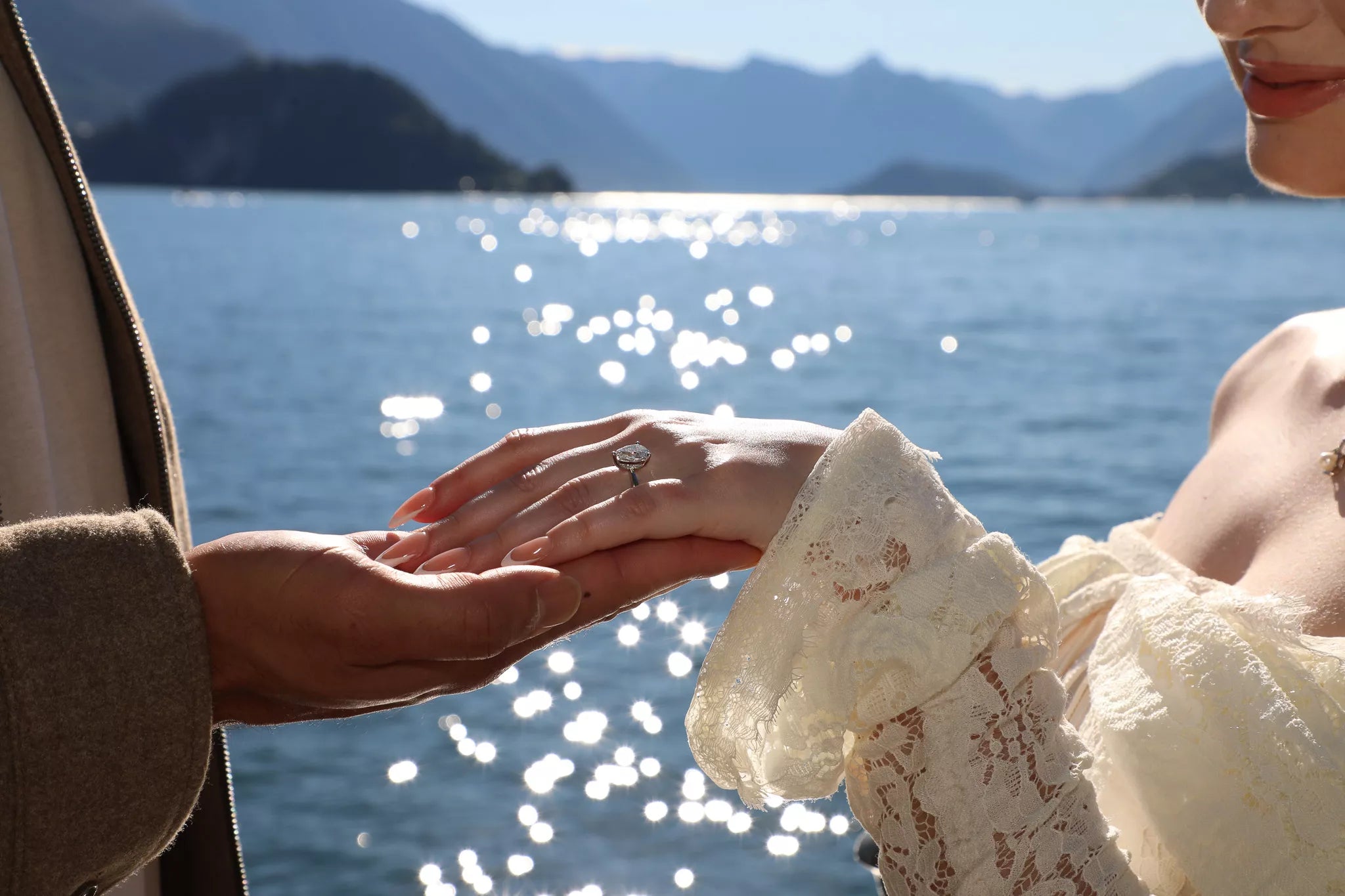 Cinematic close-up of an engagement ring and couple’s hands during a Lake Como proposal video moment