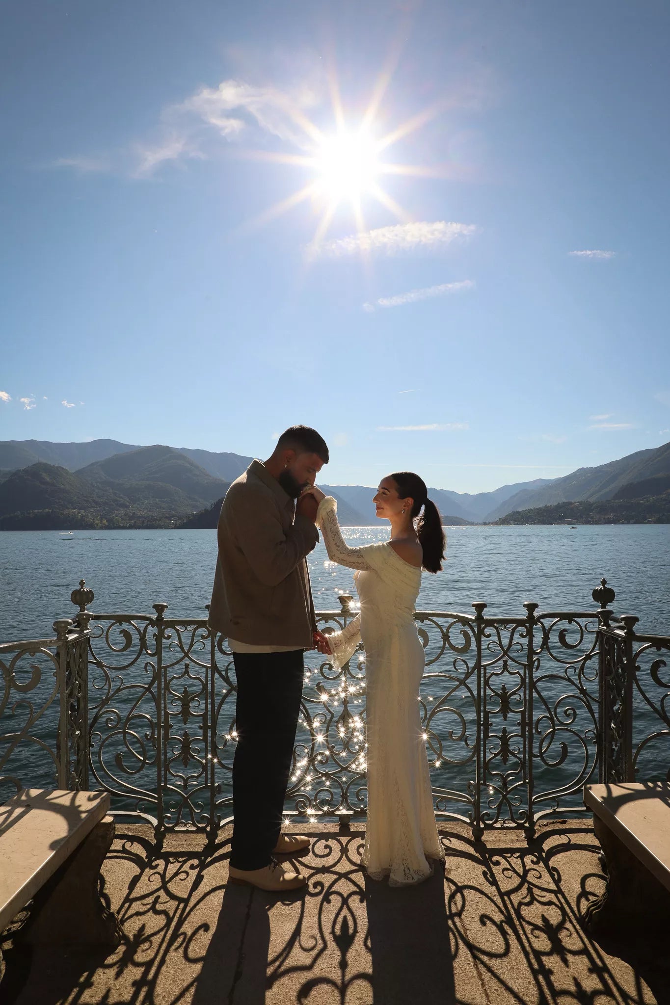 Couple sharing an intimate moment on the Villa Monastero balcony during their Lake Como Varenna engagement photo shoot