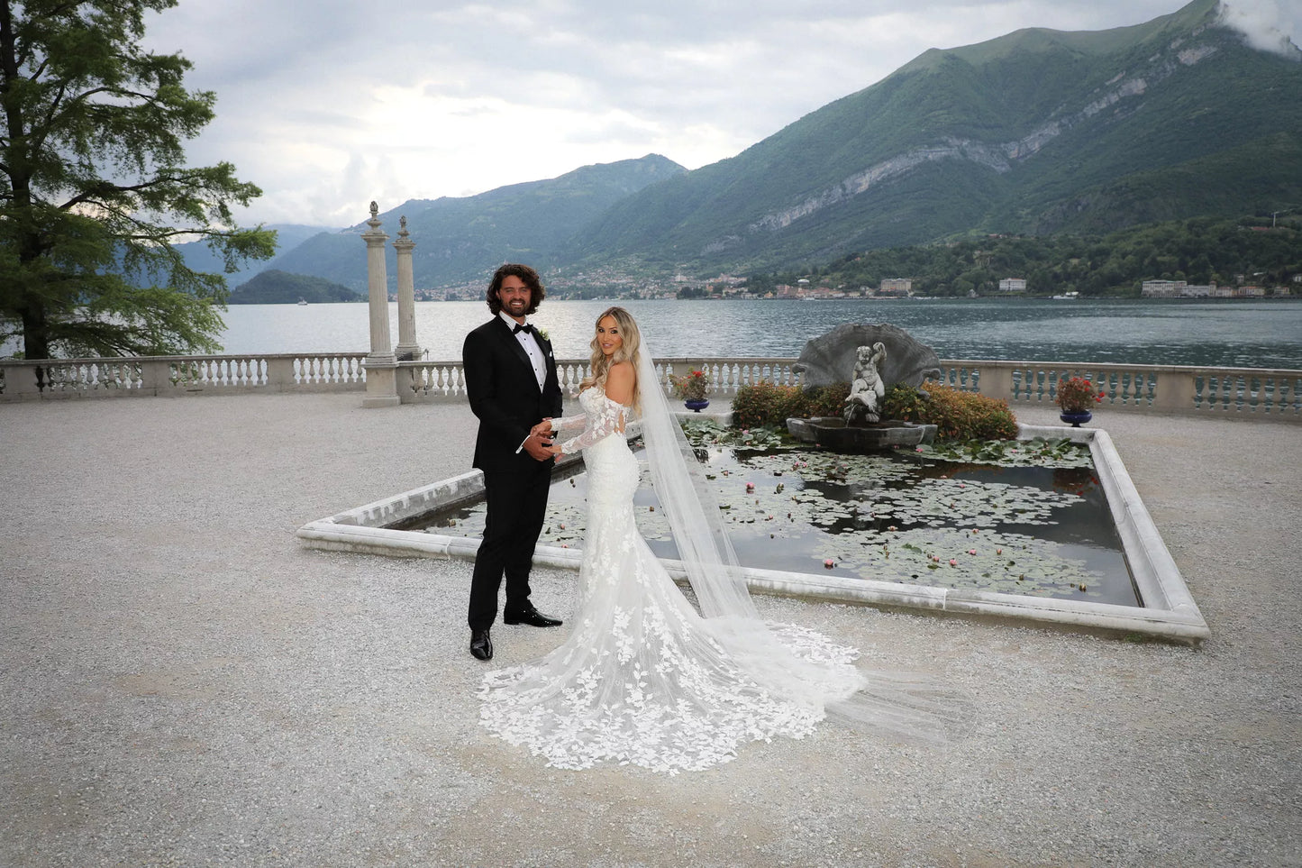Lake Como wedding boat photoshoot with bride and groom in formal wedding attire on a private boat