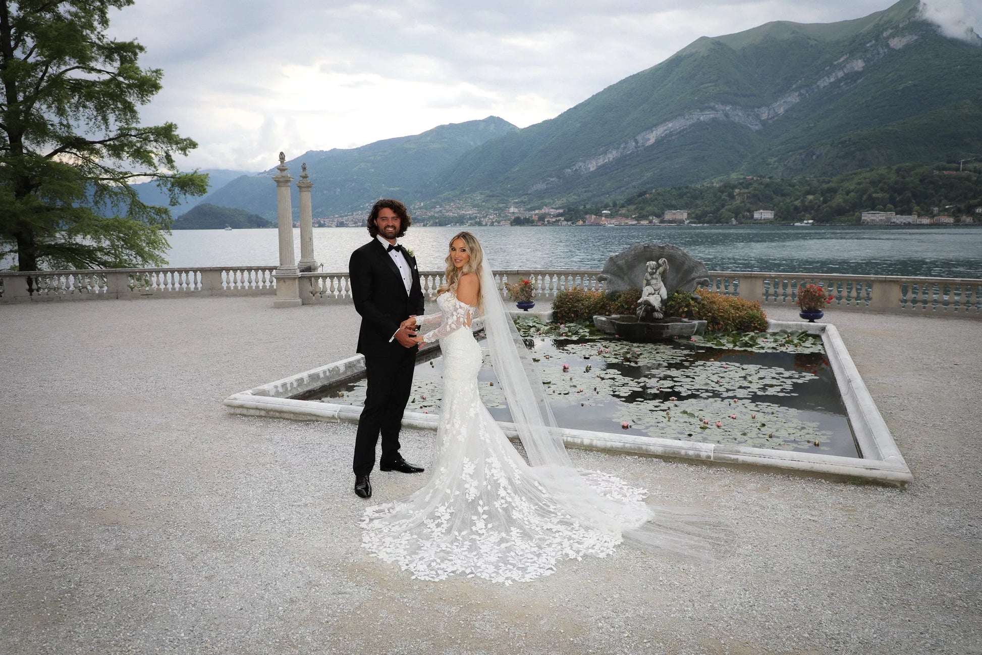 Lake Como wedding boat photoshoot with bride and groom in formal wedding attire on a private boat