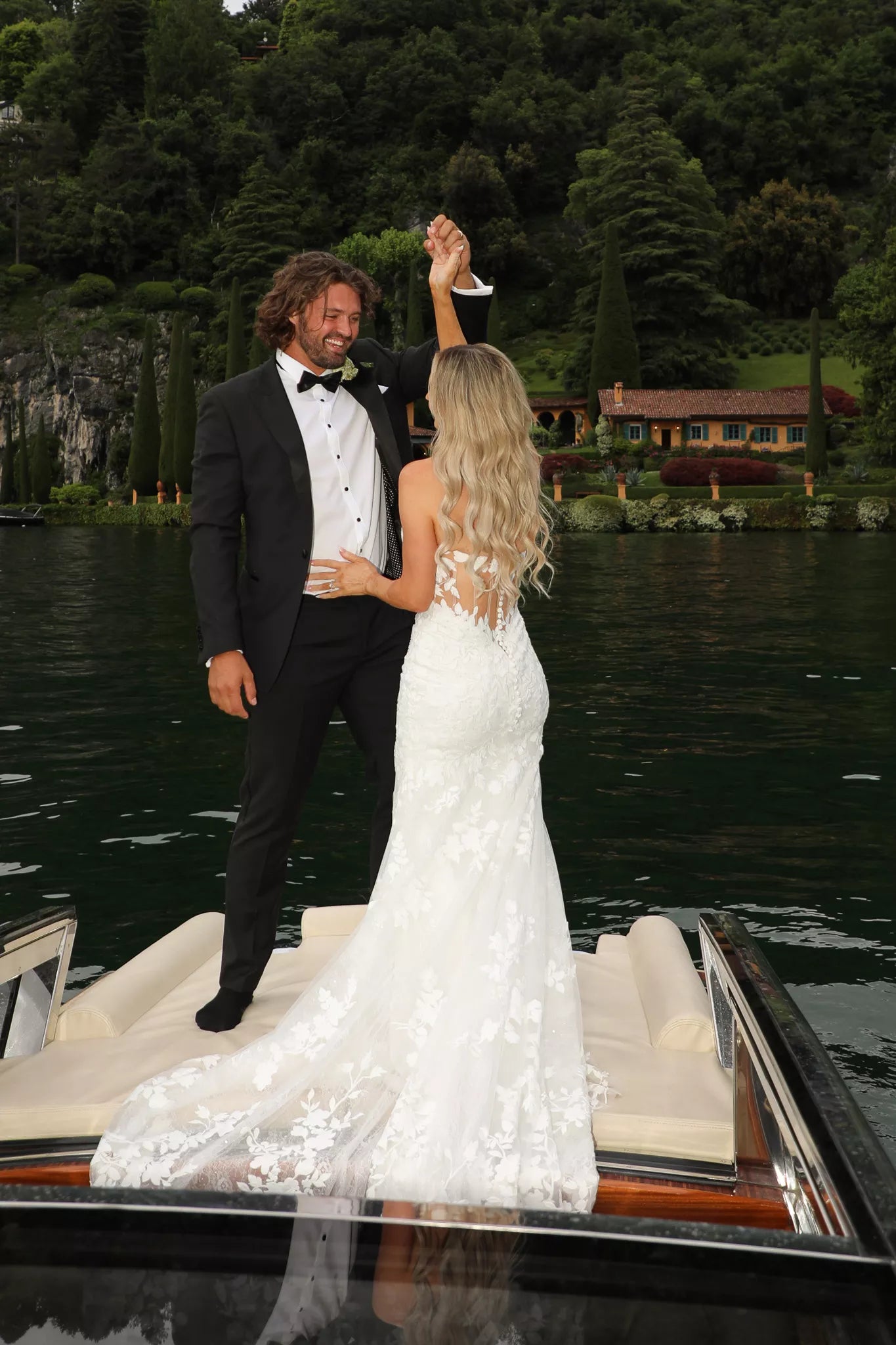 Lake Como wedding boat photoshoot with bride and groom in formal wedding attire on a private boat