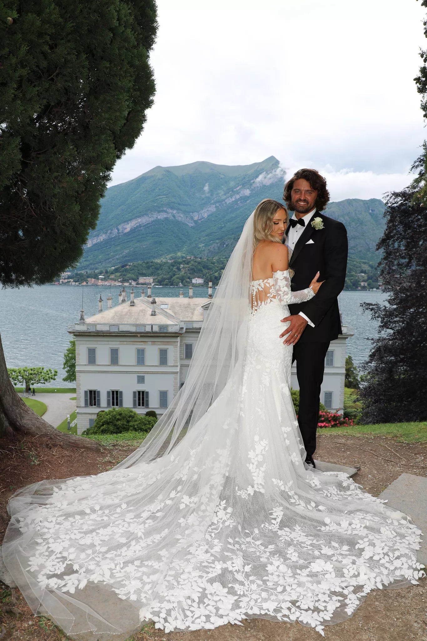 Luxury wedding photographer in Lake Como capturing bride and groom with Villa Melzi and the lake in the background