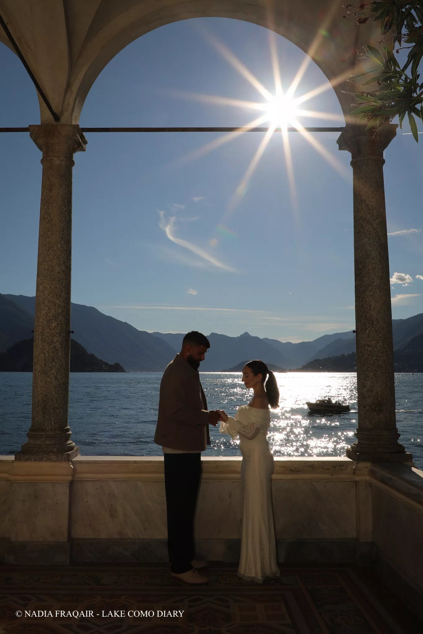 Nadia Fraqair photographing a proposal at Villa Monastero with Lake Como views in the background — cinematic editorial style.