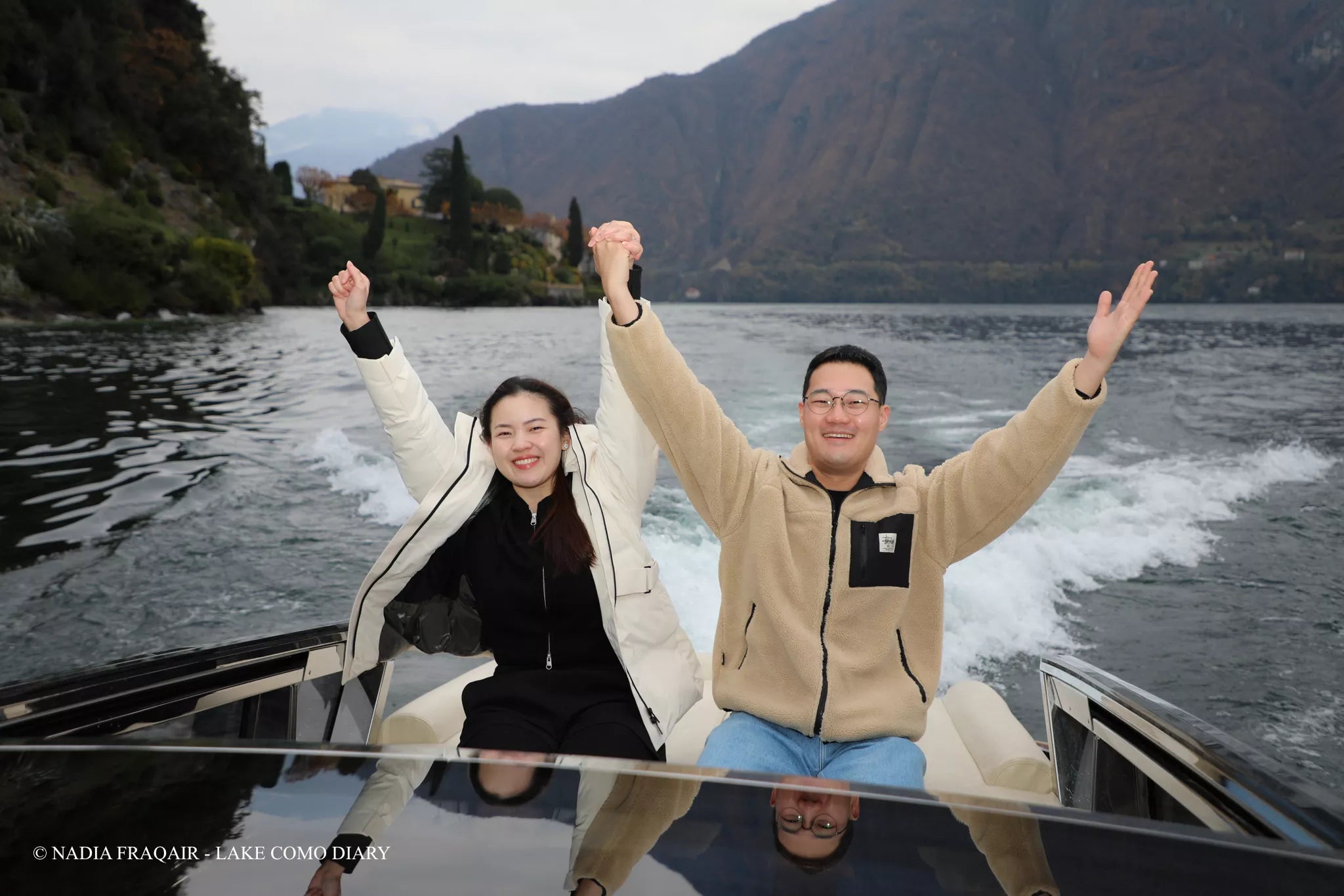 Nadia Fraqair photographing a private boat proposal on Lake Como — editorial cinematic style with natural light.