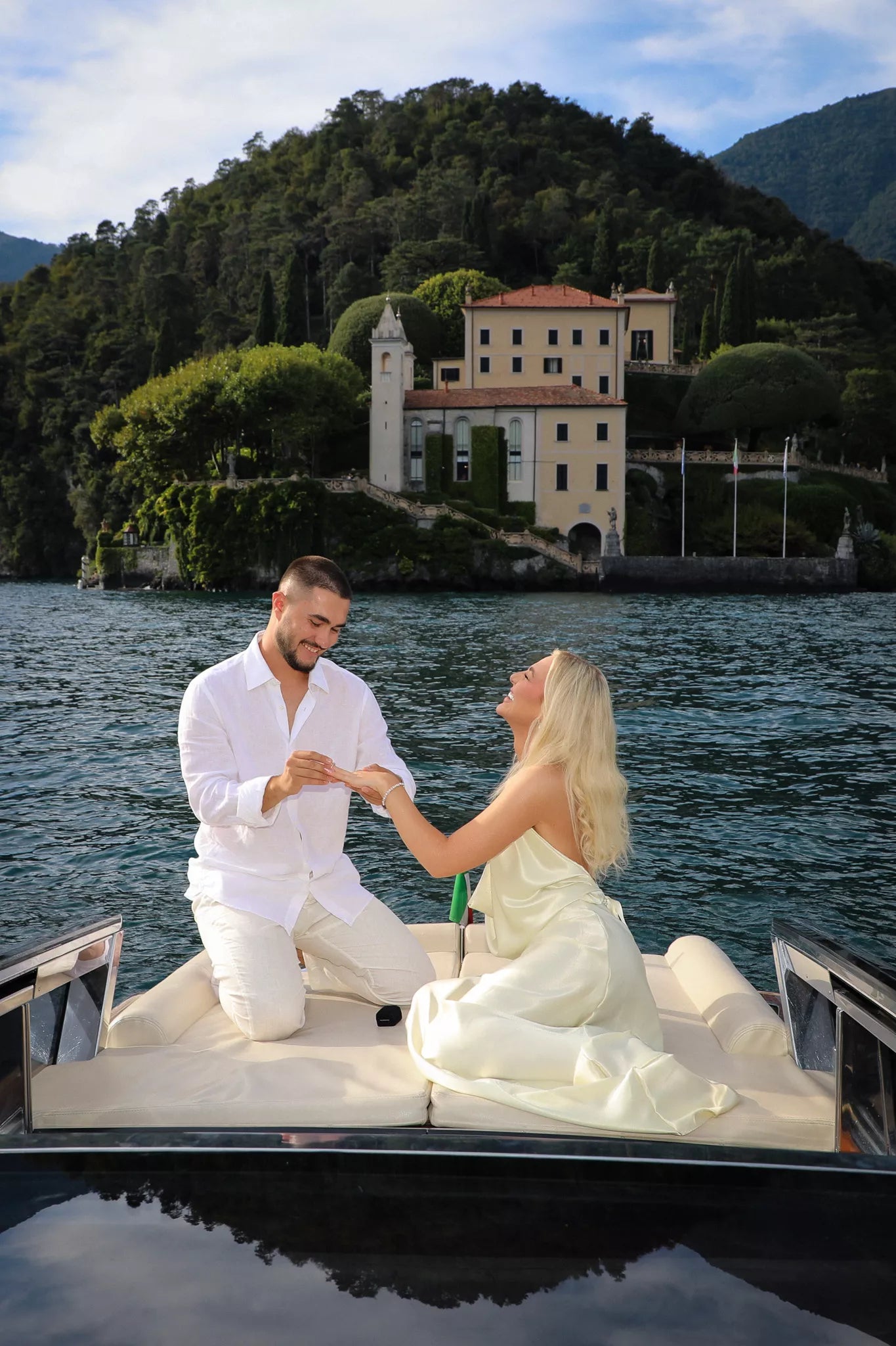 Private boat proposal on Lake Como aboard a classic wooden boat with cinematic shoreline views