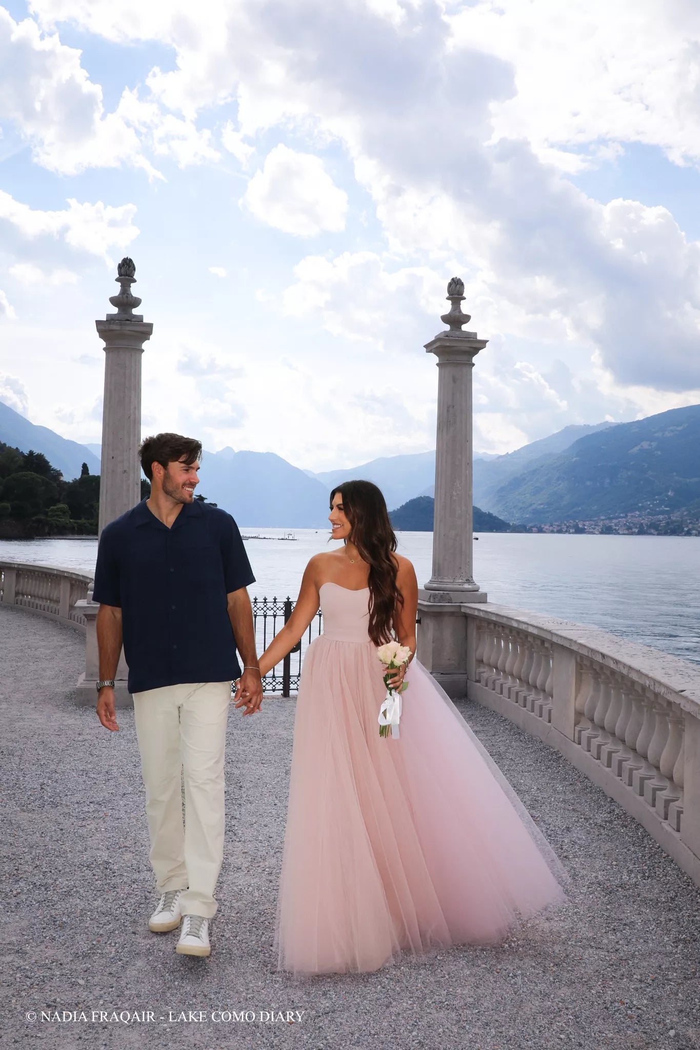 Rose dress by FRAQAIR flowing in golden hour at Villa Melzi Gardens in Bellagio during a Lake Como proposal — cinematic fashion moment.