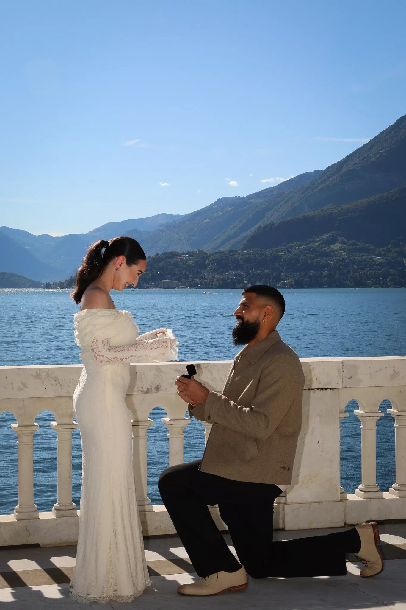 Groom-to-be kneeling in a romantic Varenna proposal on a Lake Como terrace at Villa Monastero