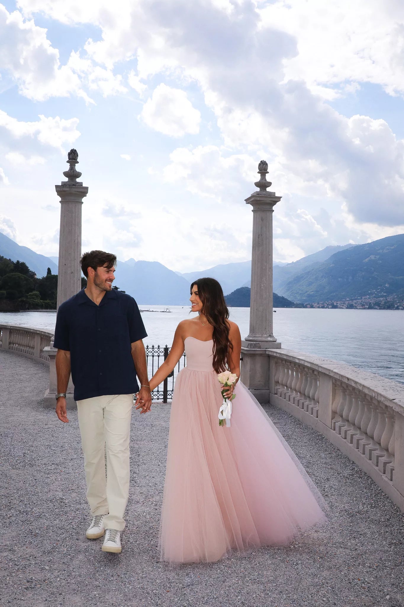 Engagement portraits after a proposal at Villa Melzi Gardens on a romantic garden path in Bellagio