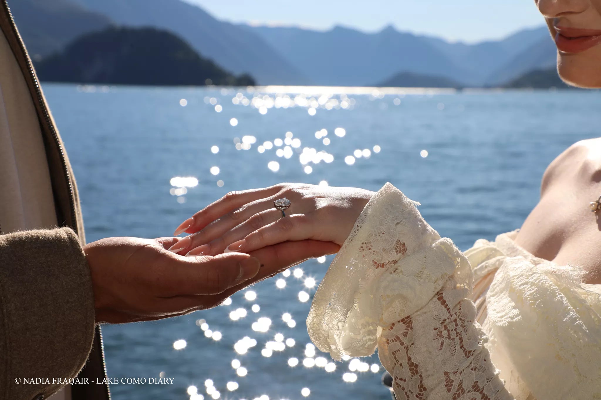 Engagement ring illuminated by sunset light during a Villa Monastero proposal in Varenna, Lake Como.